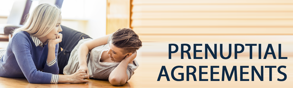 Two women laying on the floor with prenuptial agreements written in navy blue text in front of them.